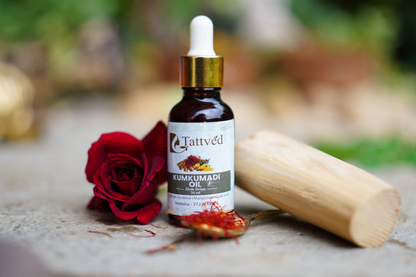 bottle of kumkumadi oil showcasing a flower and saffron