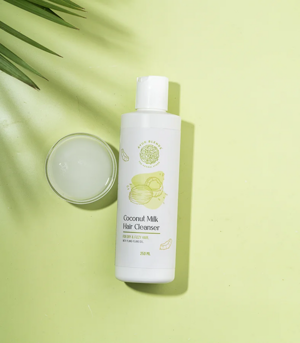 a bottle of coconut milk hair cleanser with its texture 
