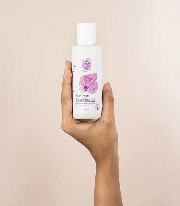 a hand holding the bottle of Fiery Soul Facial cleanser