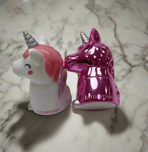 O'mumsie unicorn-shaped lip balm jars for kids in pink and white designs on a marble surface