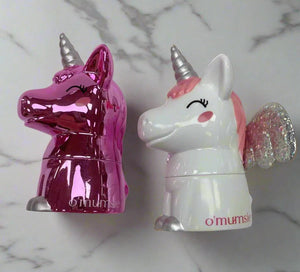 O'mumsie unicorn-shaped lip balm jars for kids in pink and white designs on a marble surface