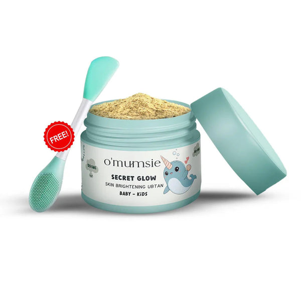 O'mumsie Secret Glow Skin Brightening Ubtan open jar showing powder texture with free applicator brush, 50gms, for baby and kids