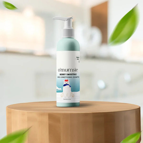 O'mumsie Berry Smoothie Kids Conditioning Shampoo bottle displayed on wooden podium in bathroom setting, mixed berries flavor, tangle free