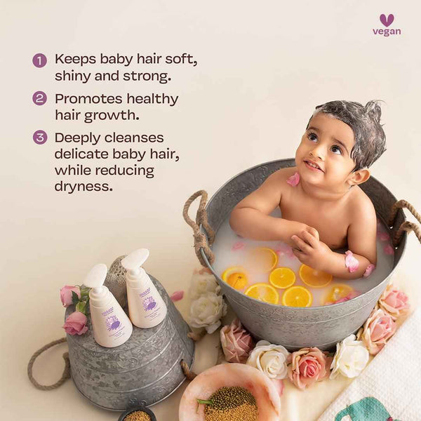Baby bathing in tub with orange slices and rose petals beside Maate Baby Shampoo bottles, natural vegan formula that keeps hair soft shiny and strong, promotes healthy growth, deeply cleanses while reducing dryness
