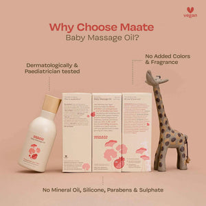 Maate Baby Massage Oil bottle and packaging boxes beside wooden giraffe toy, listing full ingredients and highlighting dermatologically and paediatrician tested, no mineral oil, silicone, parabens or sulphate
